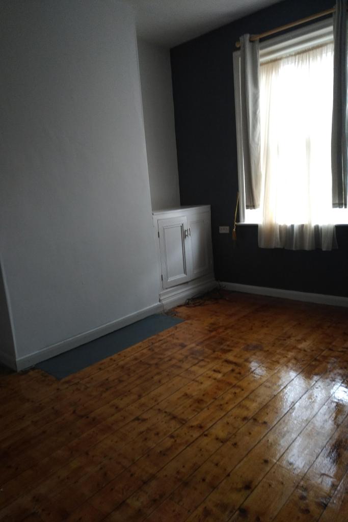 a room in a house showing polished wooden floor