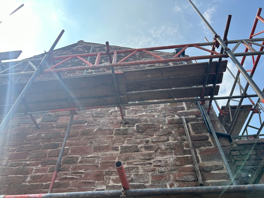 the exterior of a commercial building with scaffolding on it