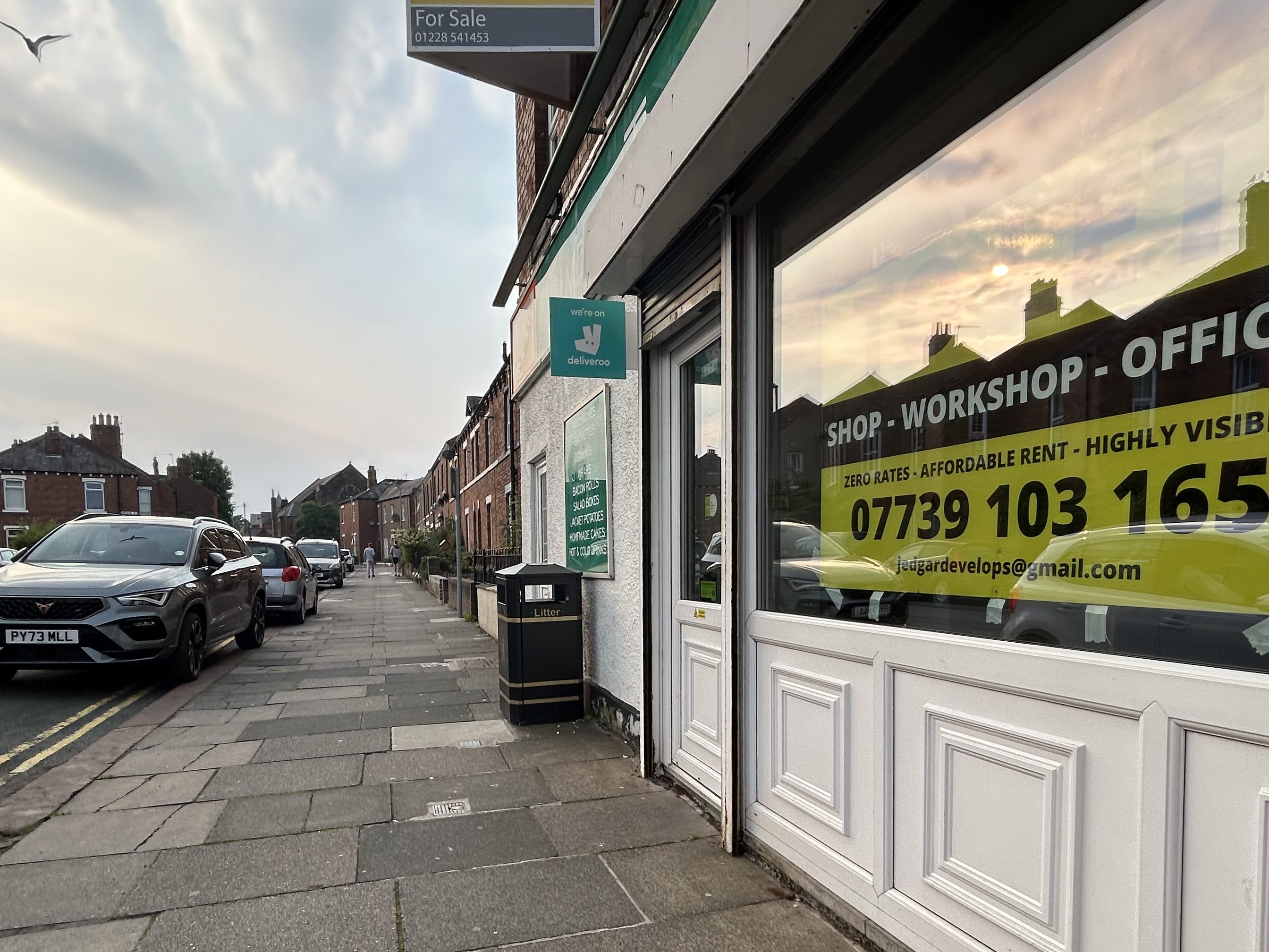 a commercial shop front with a To Let sign in the window