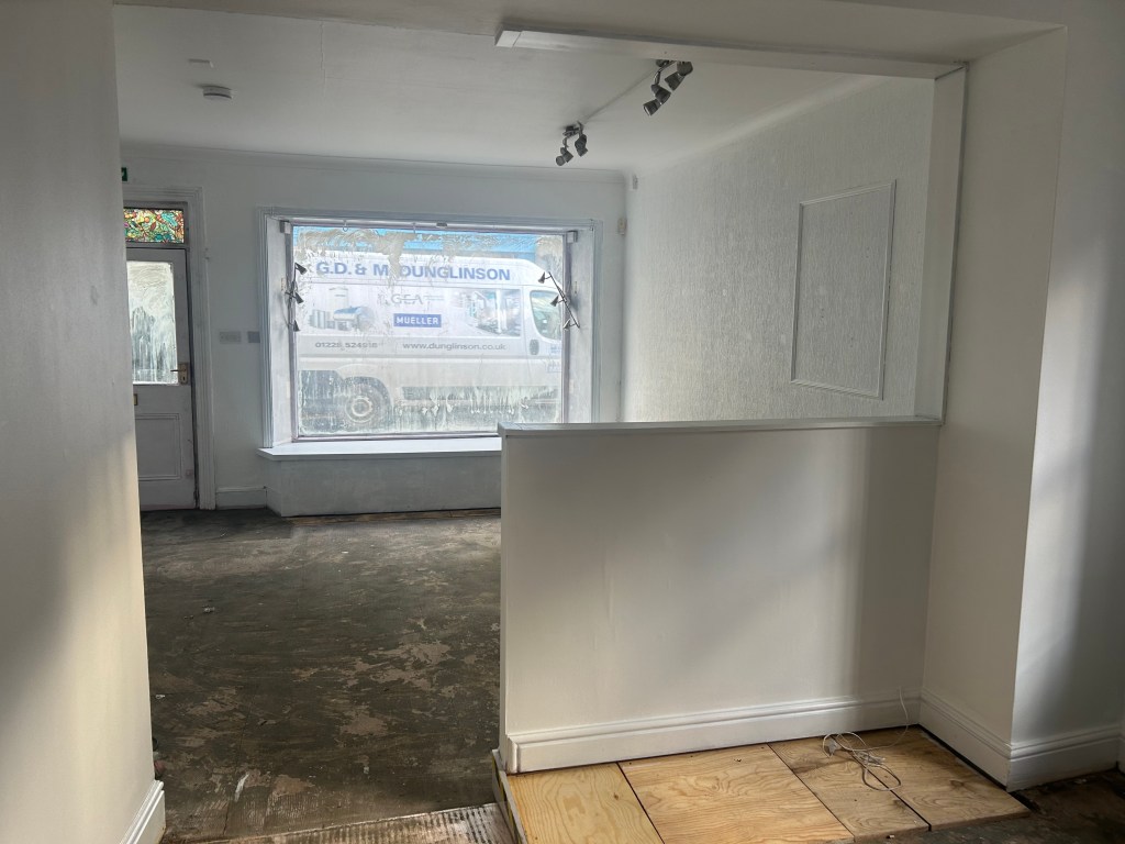 the interior of a small shop undergoing redecoration